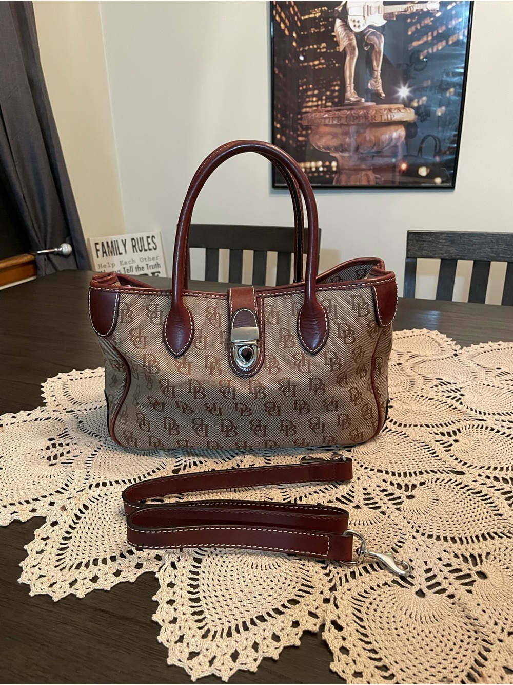 Dooney & Bourke Signature monogram satchel in brown canvas with leather trim.
